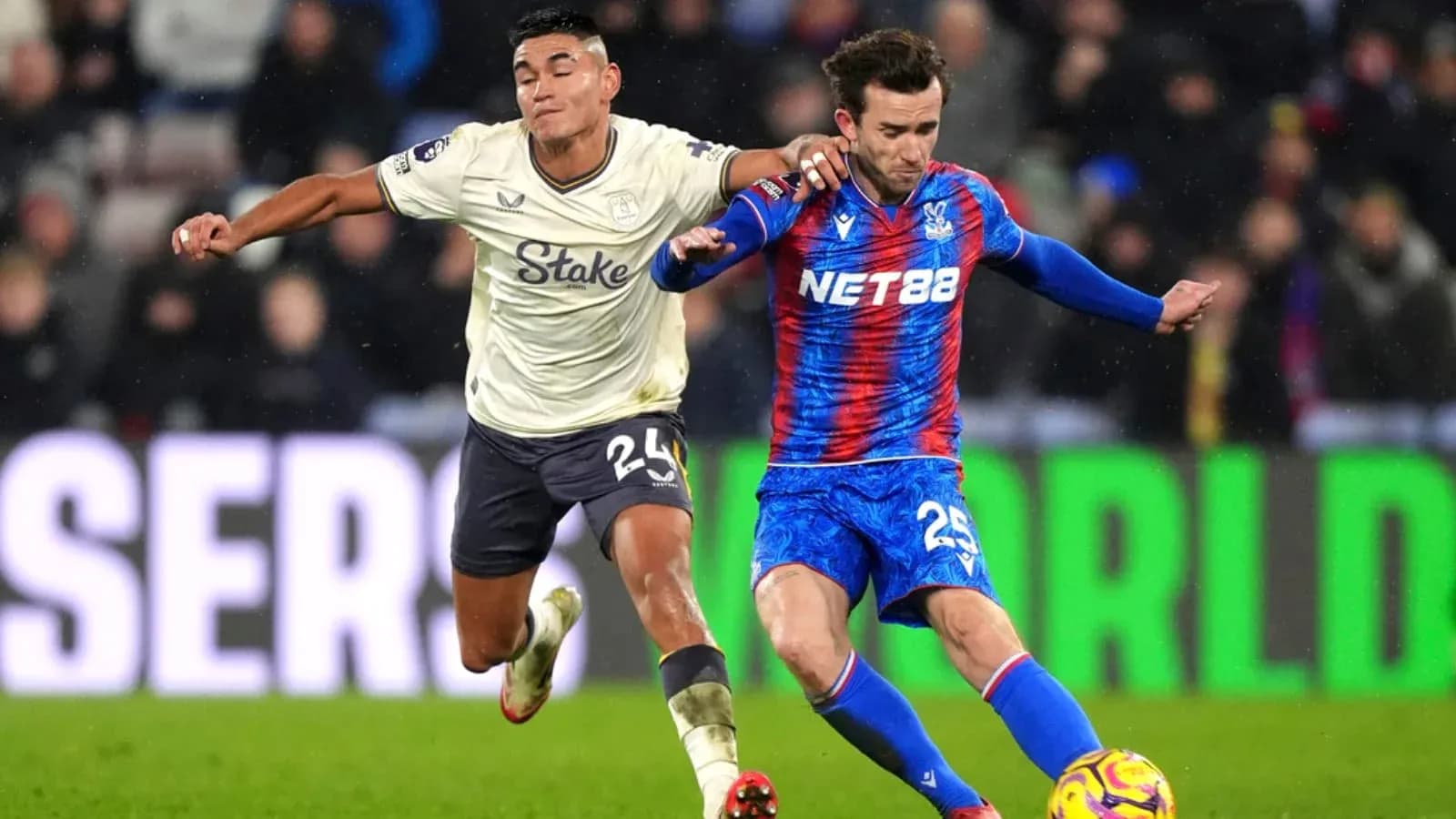 Crystal Palace player tackling Everton opponent Crystal Palace player tackling Everton opponent