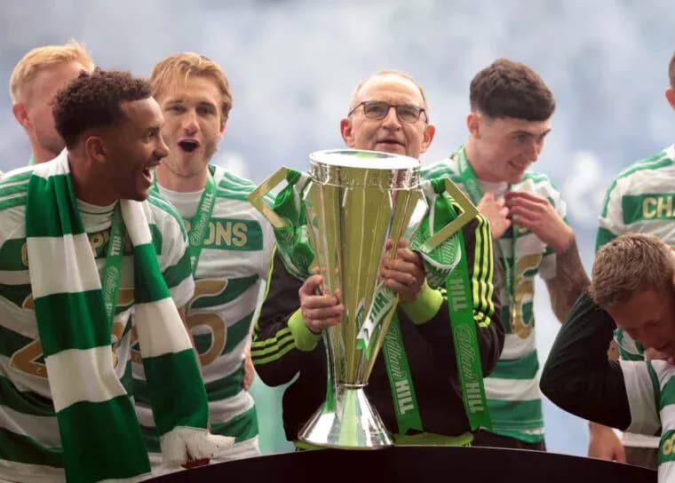 Celtic players celebrating with trophy on stage Celtic players celebrating with trophy on stage