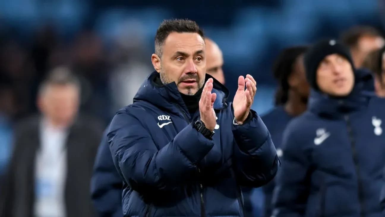 Manager applauding after match with team in background Manager applauding after match with team in background