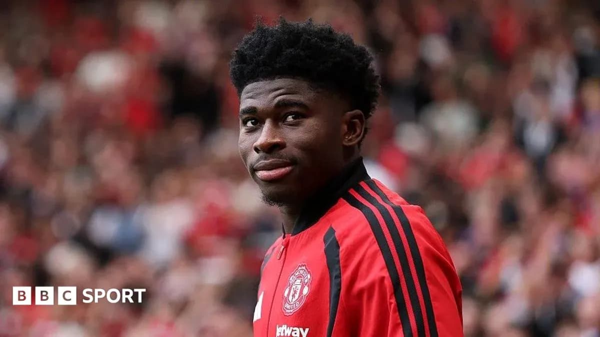 Player in Manchester United jersey on field Player in Manchester United jersey on field
