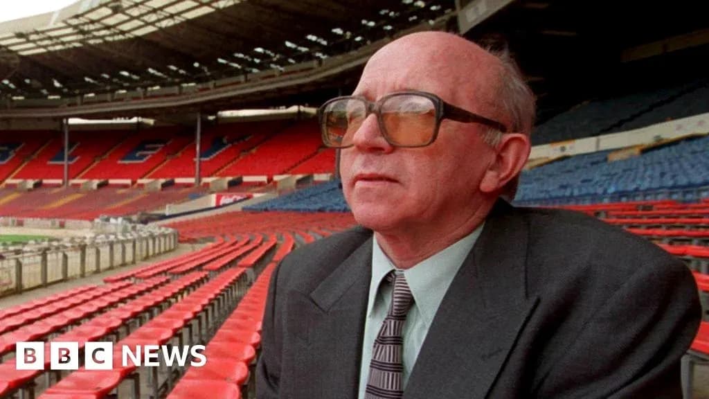 Man seated in empty stadium with red seats Man seated in empty stadium with red seats