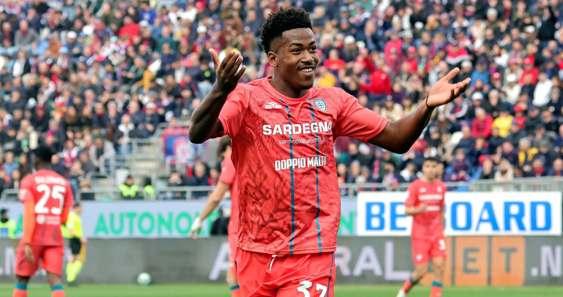 Player celebrating in red team kit during match Player celebrating in red team kit during match
