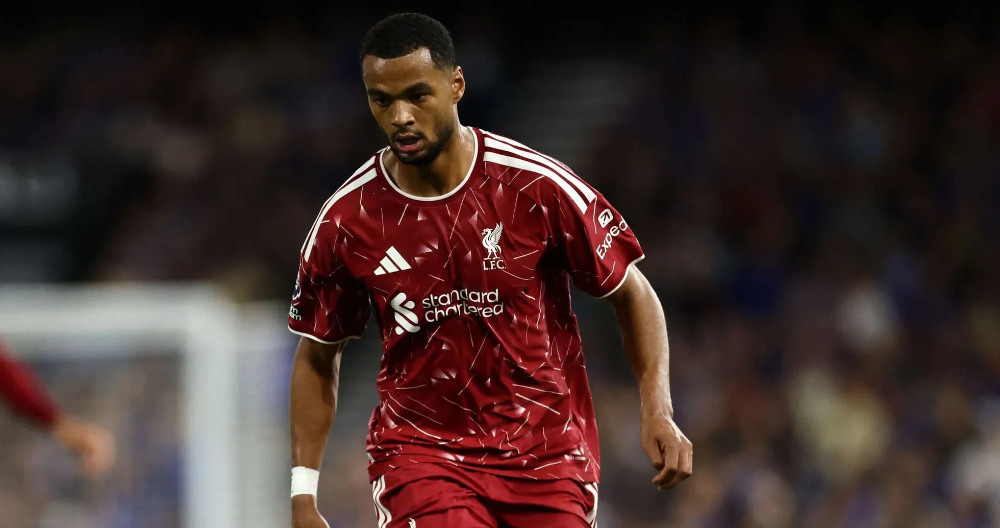 Player in red Liverpool kit running on the field Player in red Liverpool kit running on the field