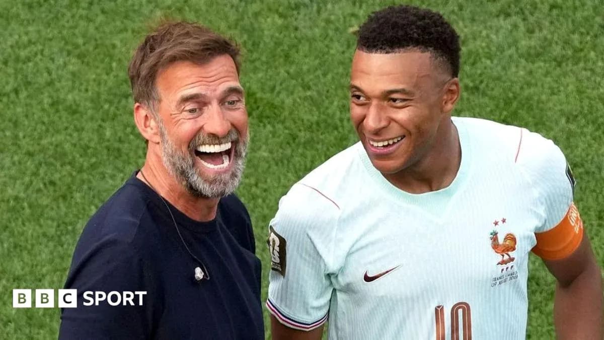 Manager and player smiling on the pitch Manager and player smiling on the pitch