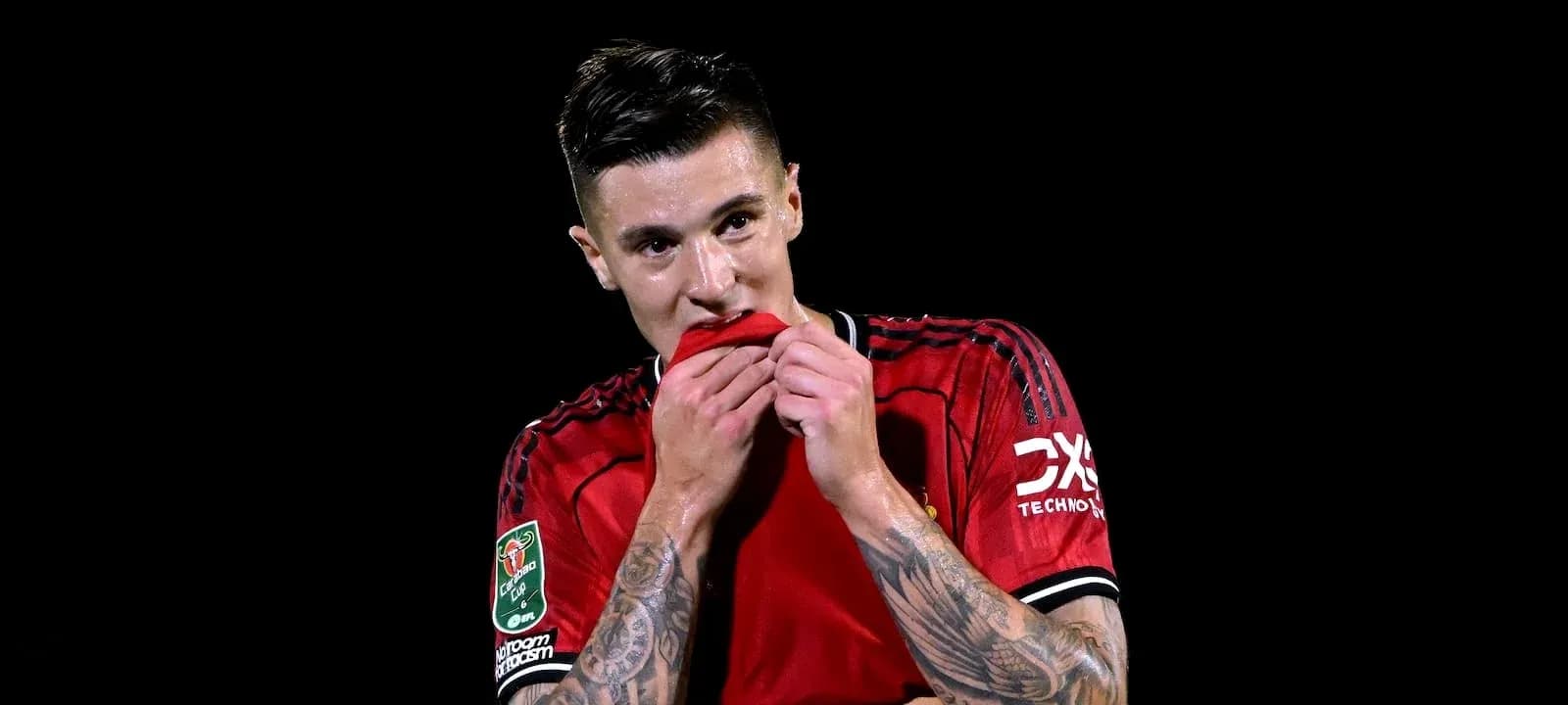 Player in red jersey biting his shirt Player in red jersey biting his shirt