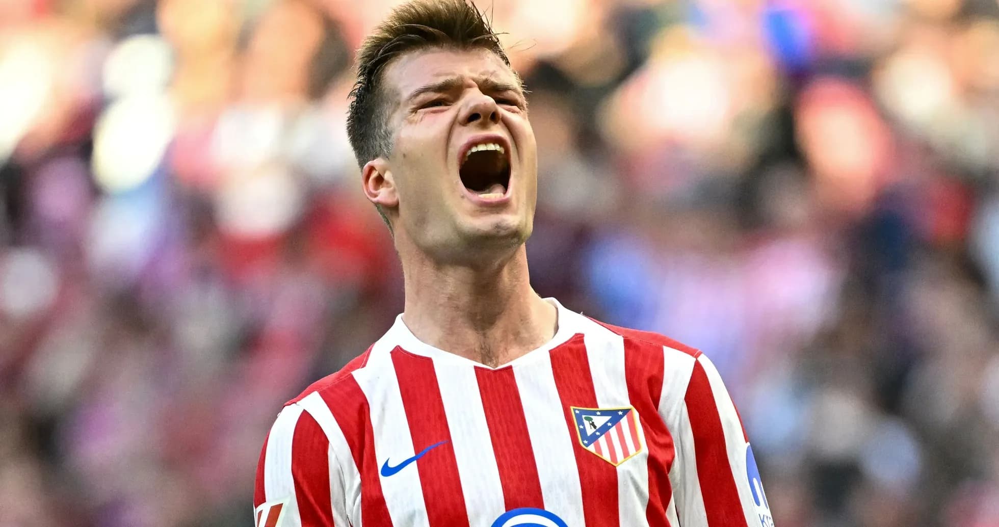 Atletico Madrid player celebrating passionately on field Atletico Madrid player celebrating passionately on field