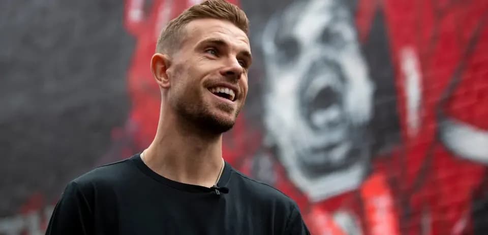 Player smiling in front of mural background Player smiling in front of mural background