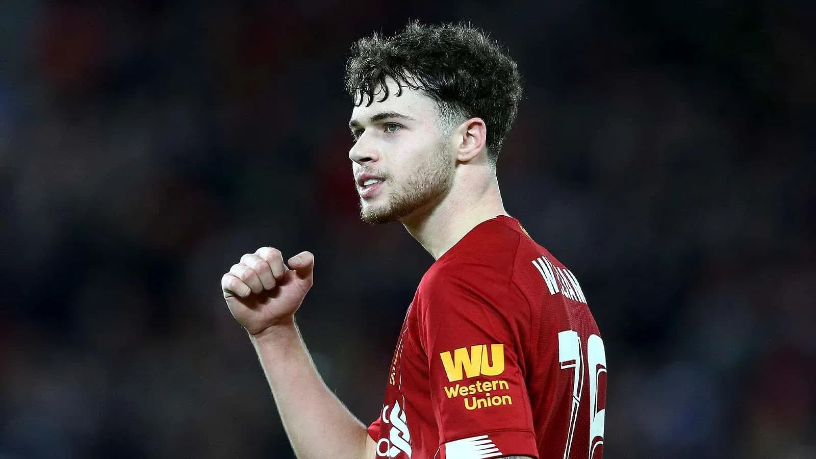 Player celebrating during match in Liverpool kit Player celebrating during match in Liverpool kit
