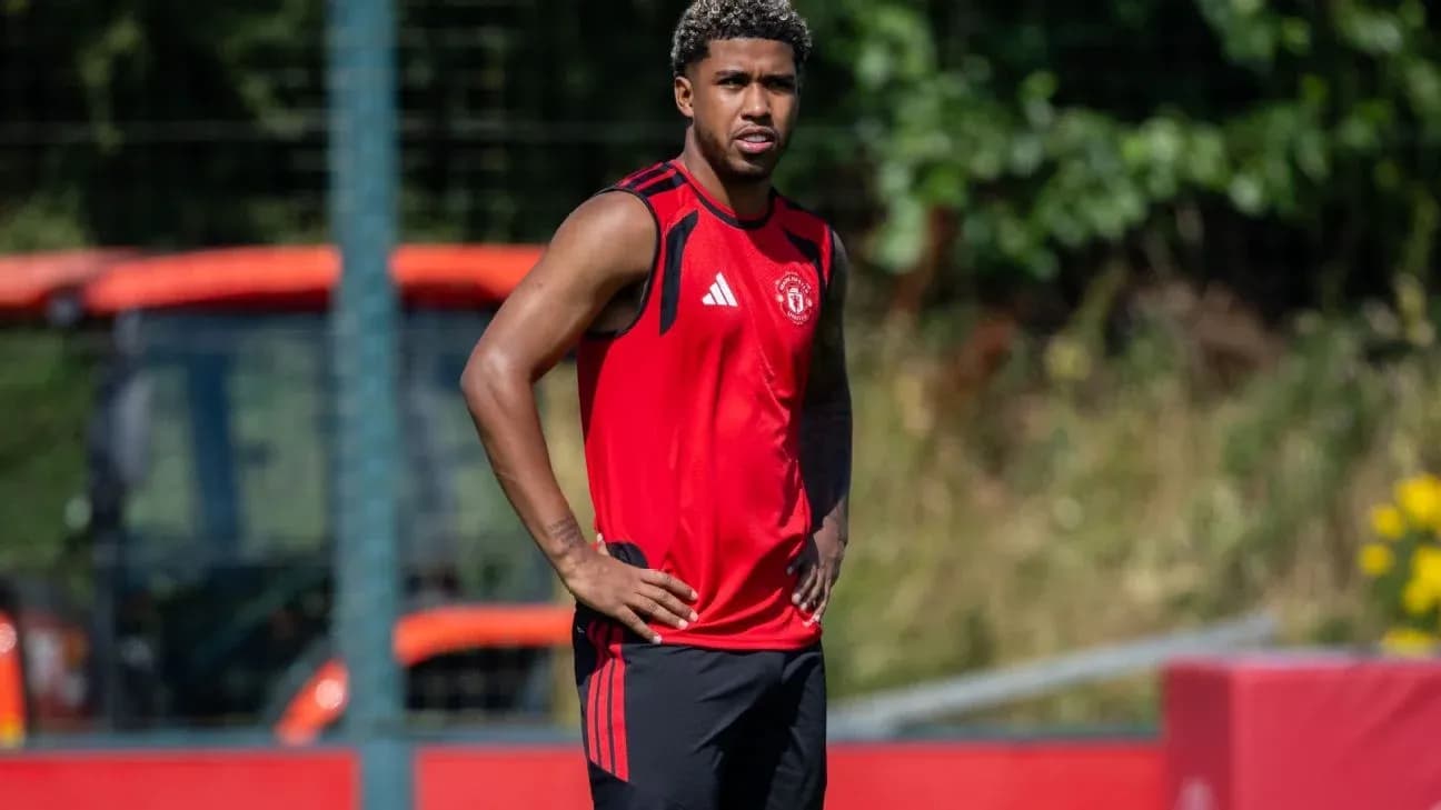 Player in red training kit during practice session Player in red training kit during practice session