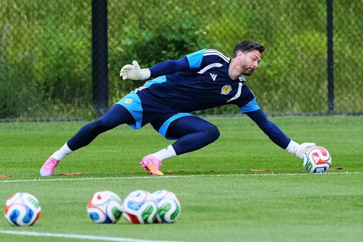 Goalkeeper diving to catch a soccer ball during training Goalkeeper diving to catch a soccer ball during training