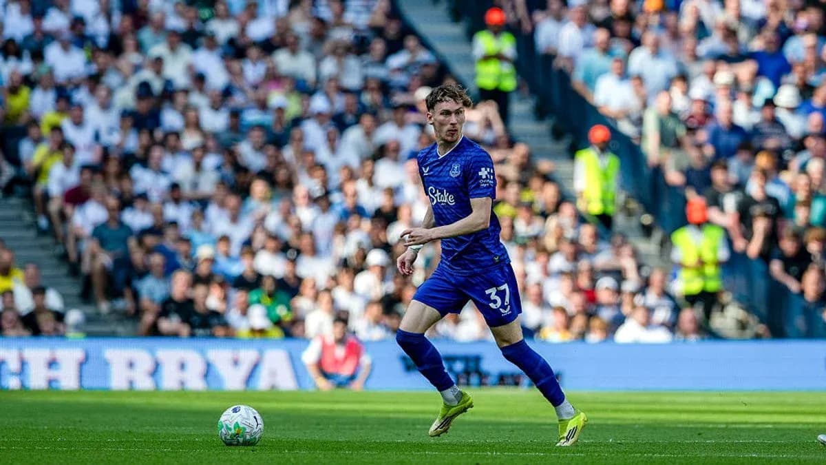 Player in blue kit running on the field Player in blue kit running on the field
