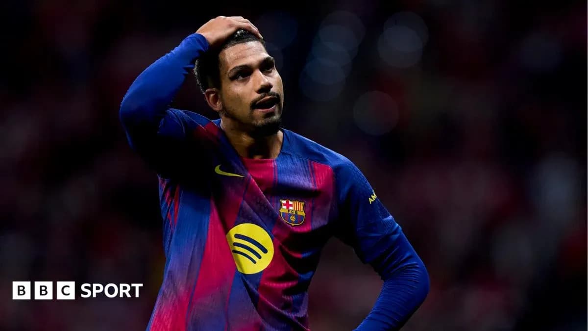 Barcelona player holding head in disappointment on field Barcelona player holding head in disappointment on field