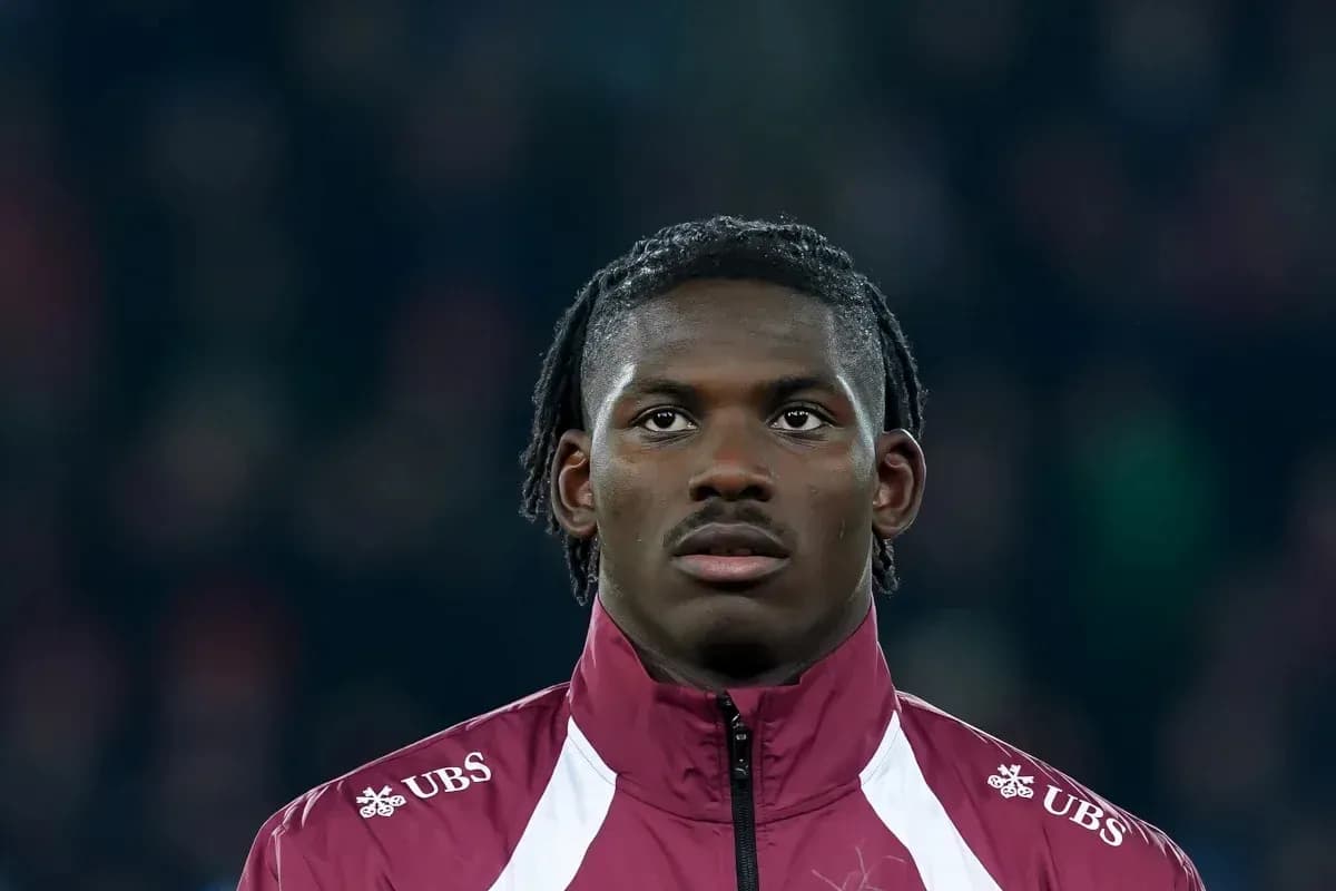 Player in maroon jacket during match preparation Player in maroon jacket during match preparation
