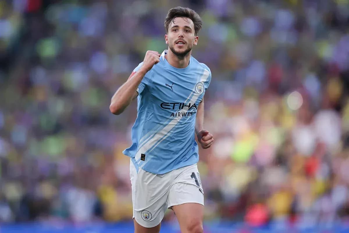 Player celebrating after scoring a goal for Manchester City Player celebrating after scoring a goal for Manchester City