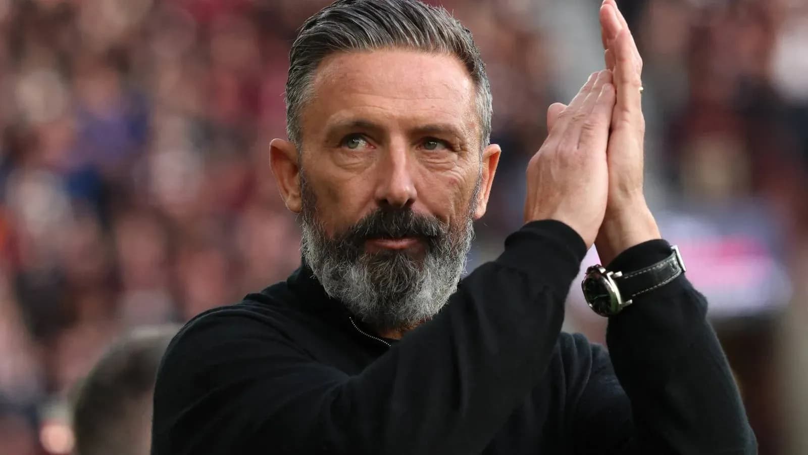 Coach applauding fans during a match Coach applauding fans during a match