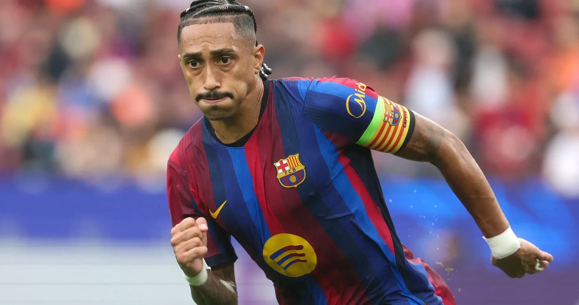 Player running on the pitch wearing Barcelona jersey Player running on the pitch wearing Barcelona jersey