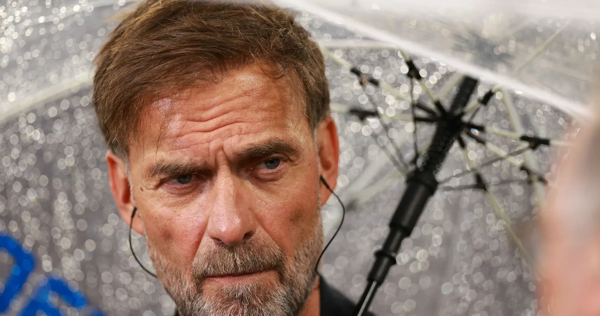 Man with umbrella during a rainy press conference Man with umbrella during a rainy press conference
