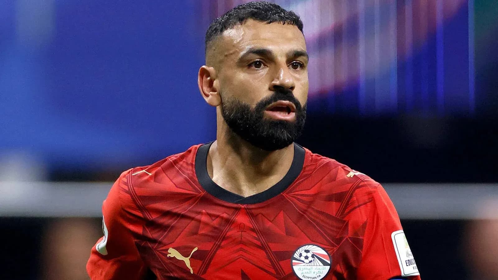 Player in red jersey during football match Player in red jersey during football match