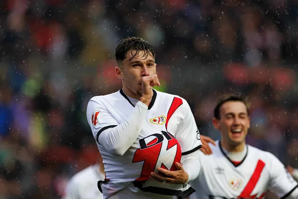 Player celebrating a goal with teammates in rain Player celebrating a goal with teammates in rain