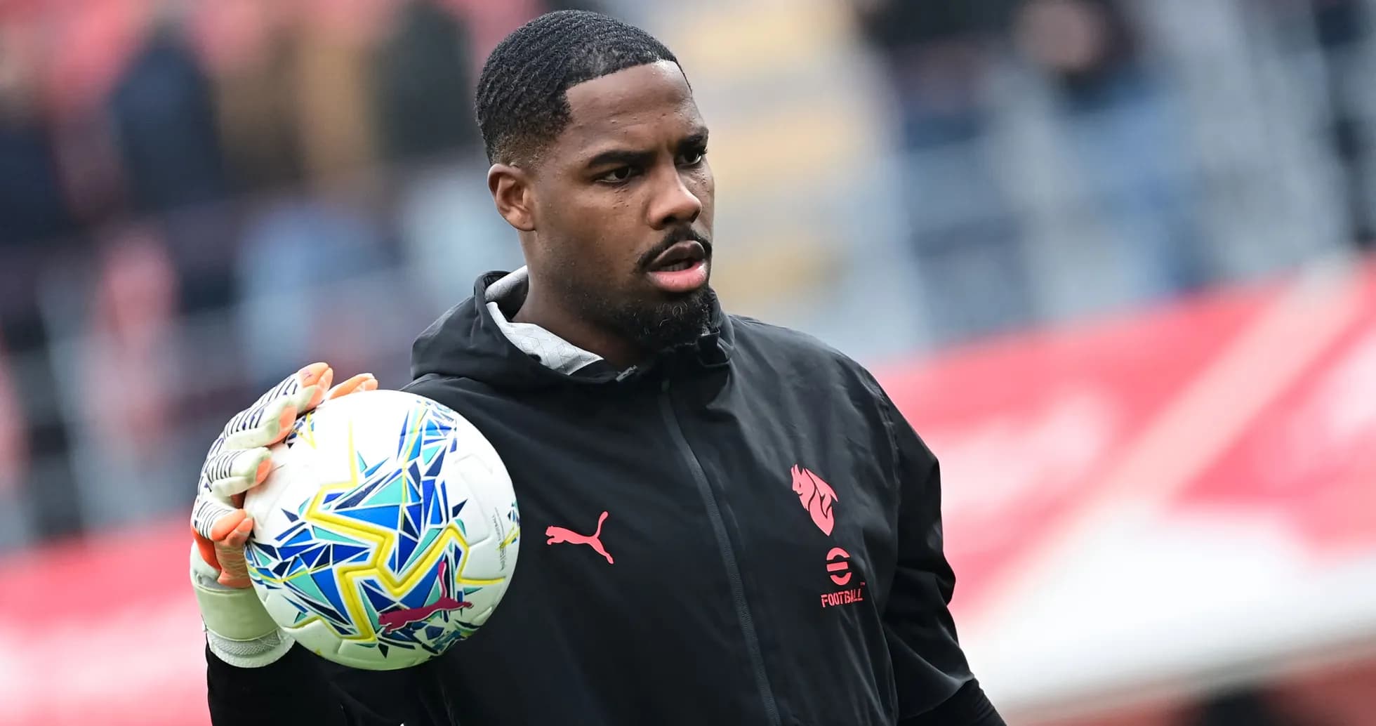 Goalkeeper holding a colorful football before match Goalkeeper holding a colorful football before match