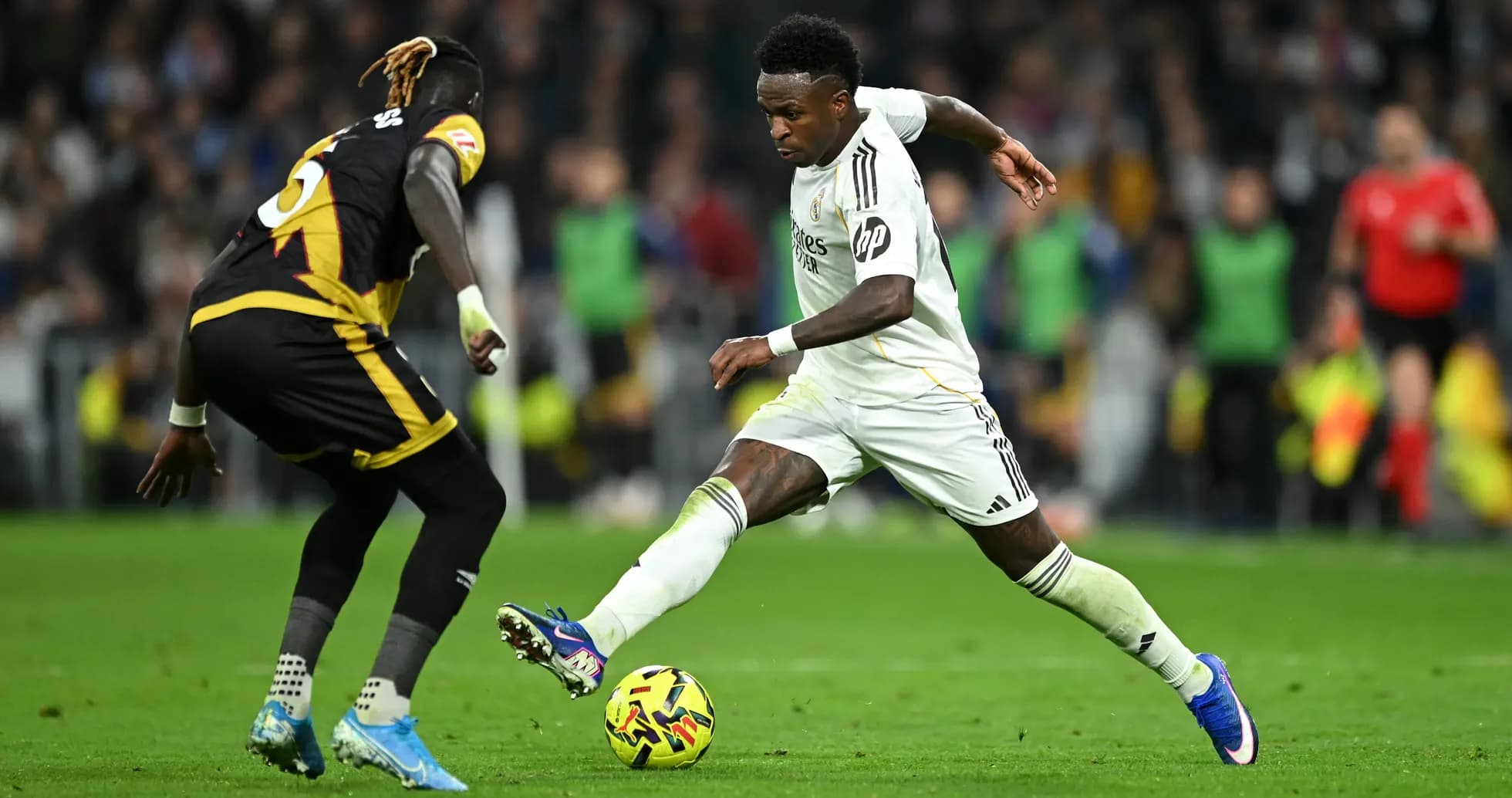 Vinicius Jr. dribbling past Rayo Vallecano player Vinicius Jr. dribbling past Rayo Vallecano player