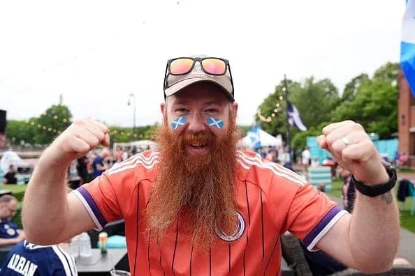Fan celebrating with face paint and jersey Fan celebrating with face paint and jersey