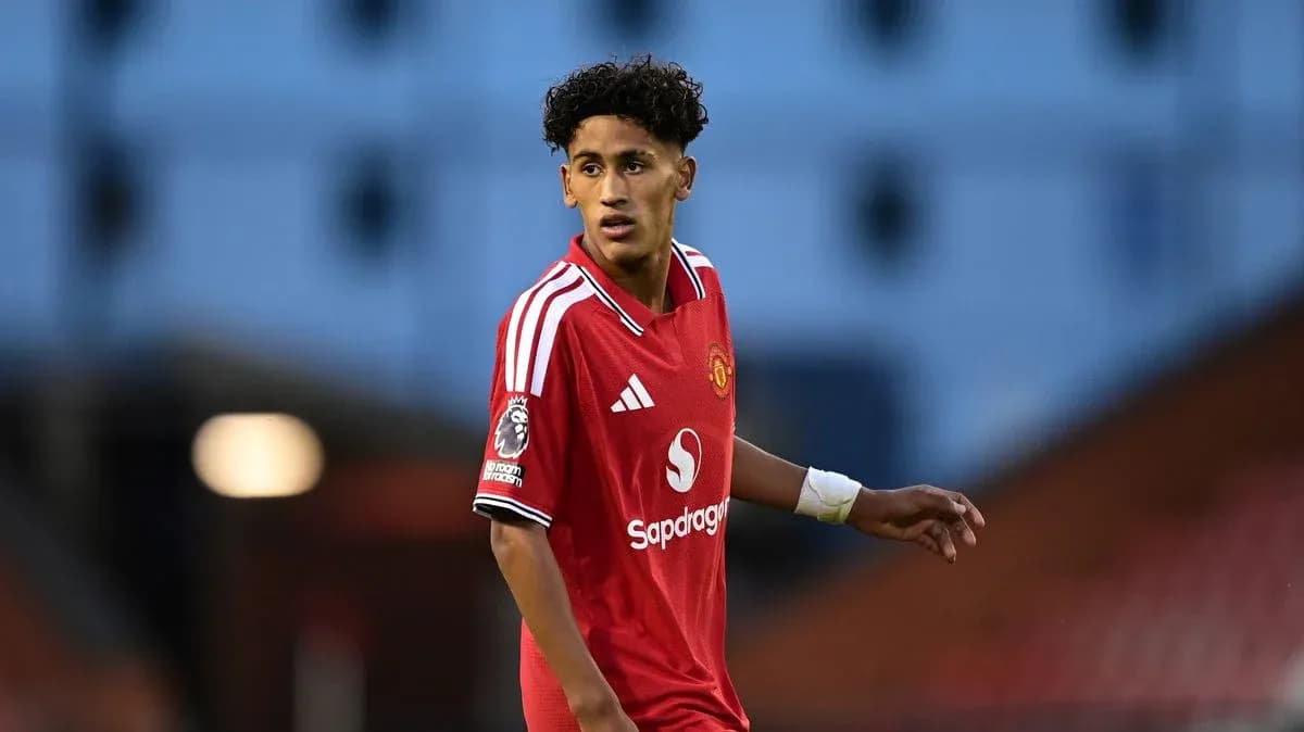 Young player in Manchester United kit on field Young player in Manchester United kit on field