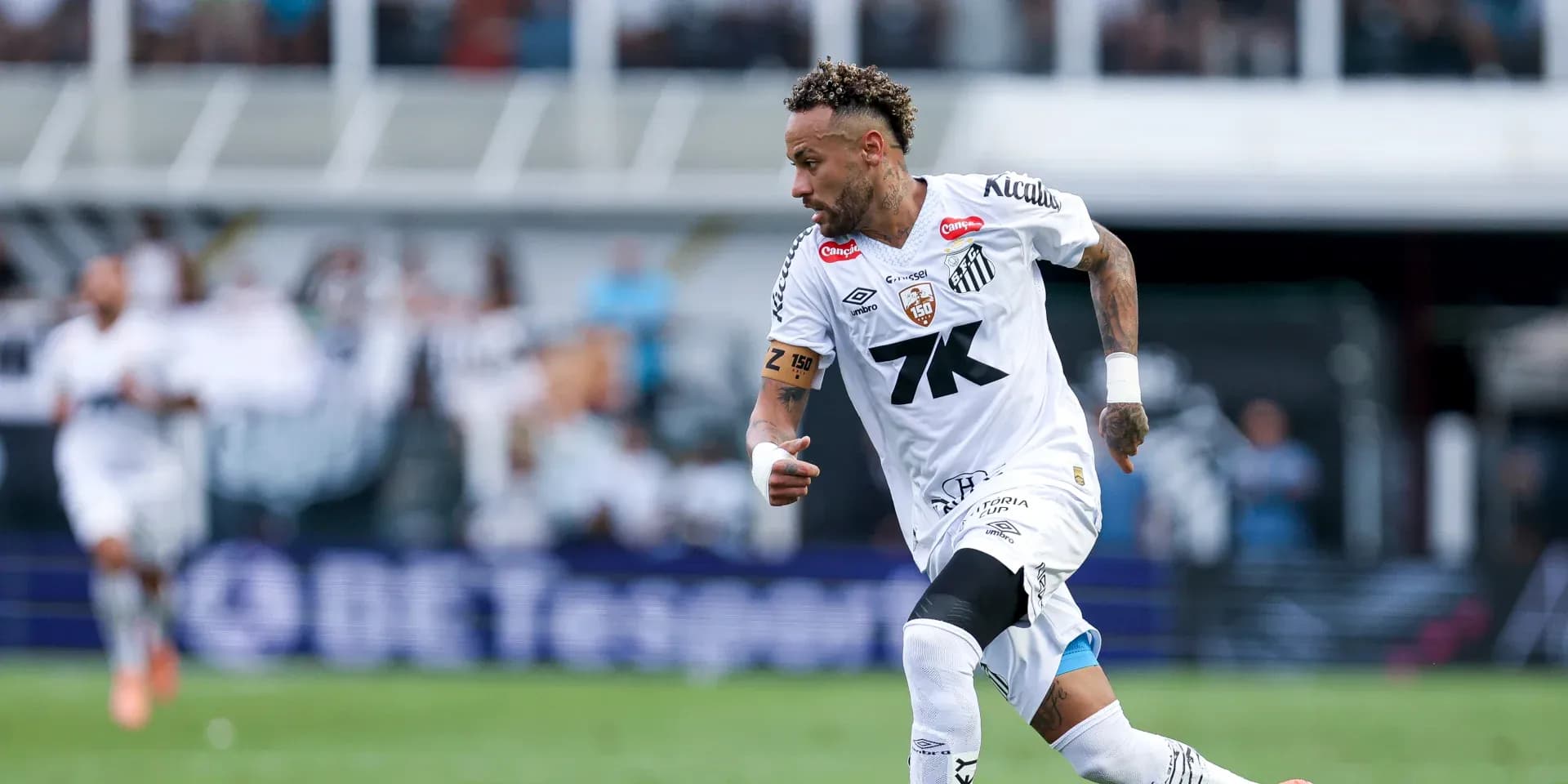 Player sprinting during a Santos FC match Player sprinting during a Santos FC match