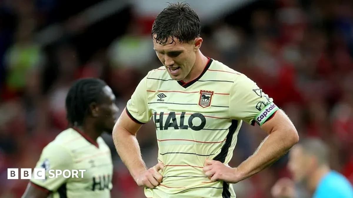 Player looking down in disappointment on the pitch Player looking down in disappointment on the pitch