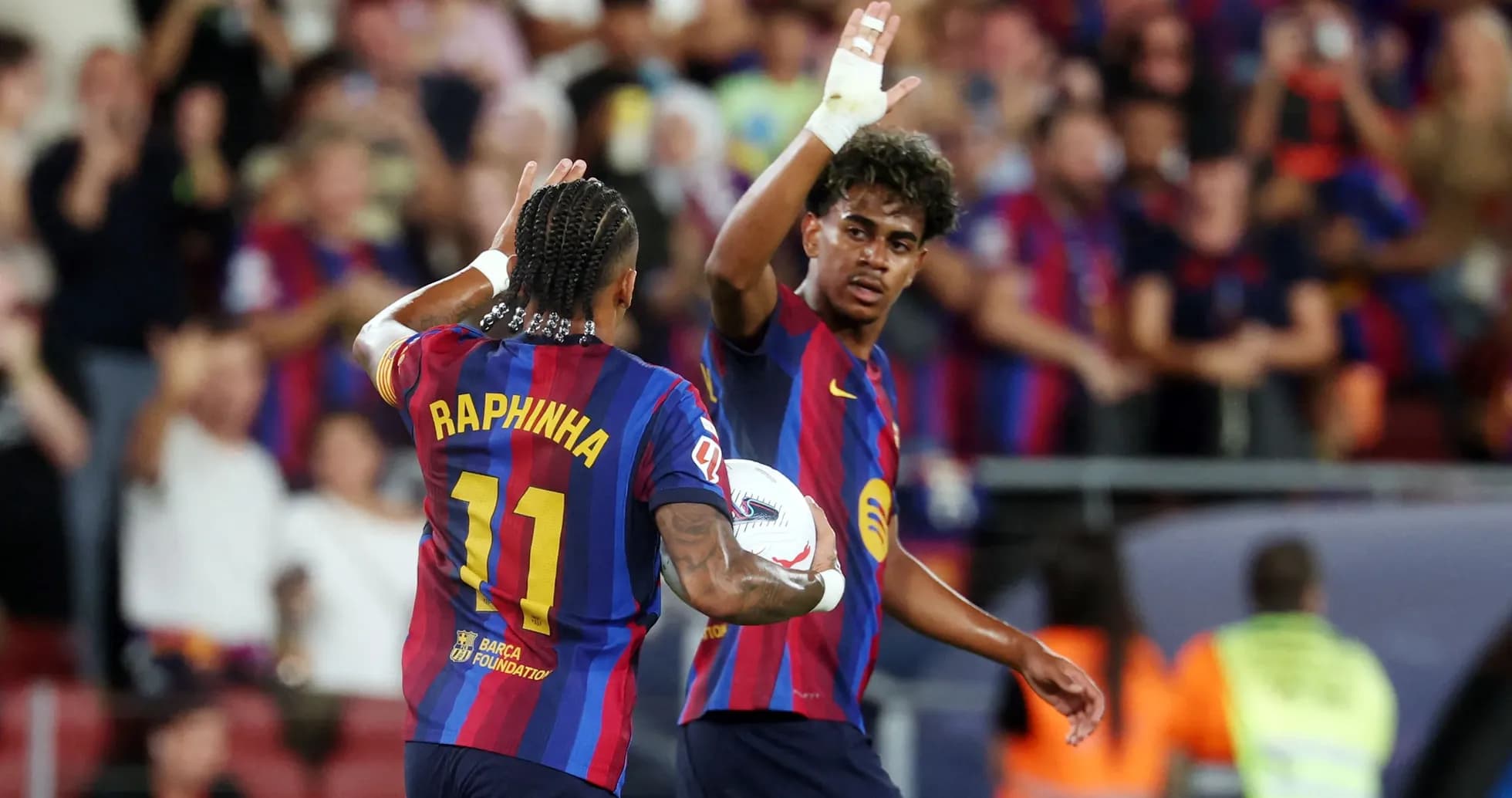 Two FC Barcelona players celebrating on the pitch Two FC Barcelona players celebrating on the pitch