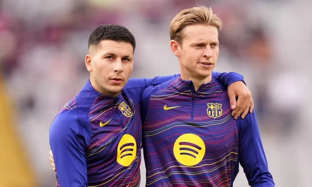 Two players in Barcelona training kits embracing Two players in Barcelona training kits embracing