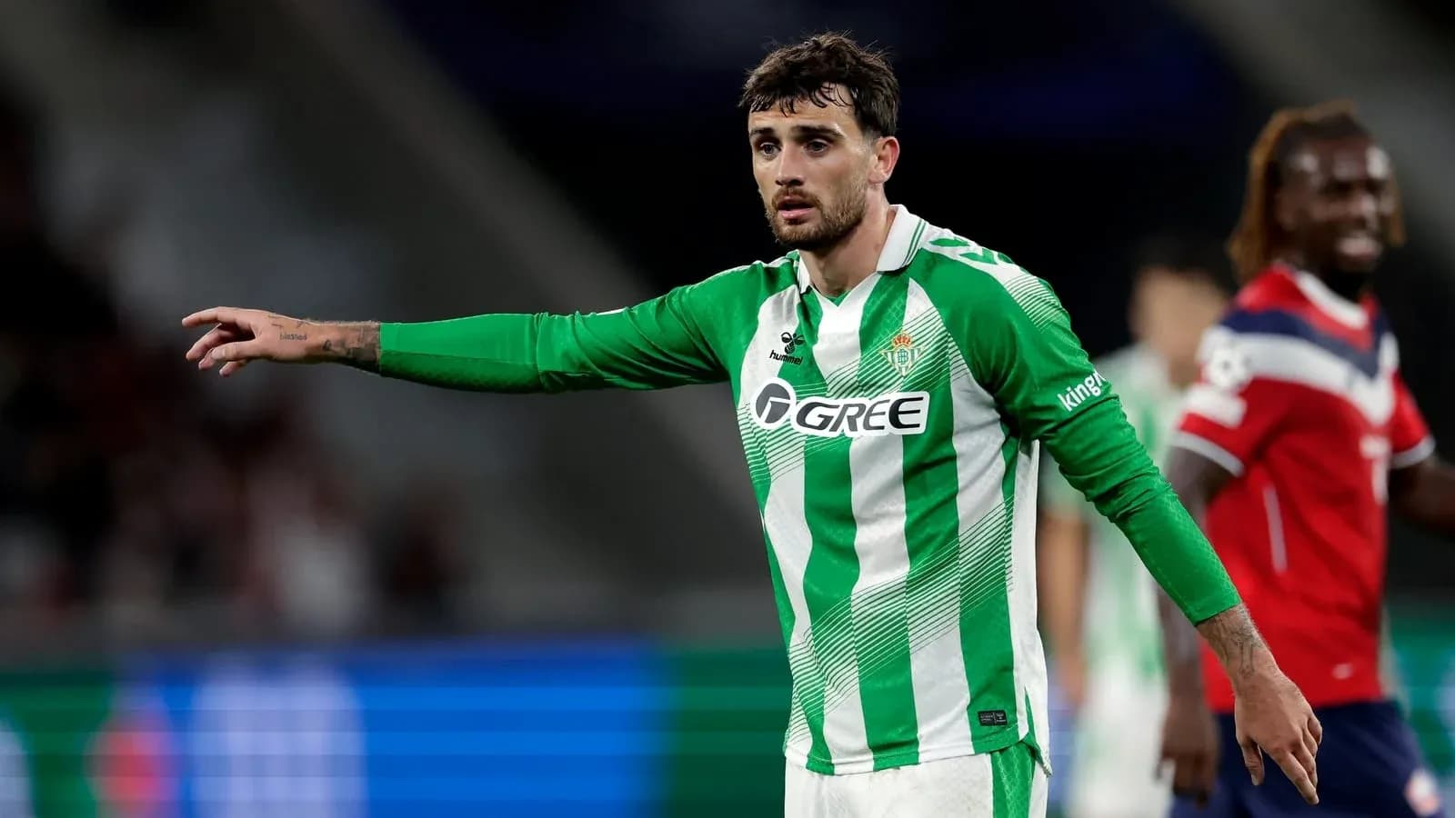 Player in green jersey gesturing during a match Player in green jersey gesturing during a match