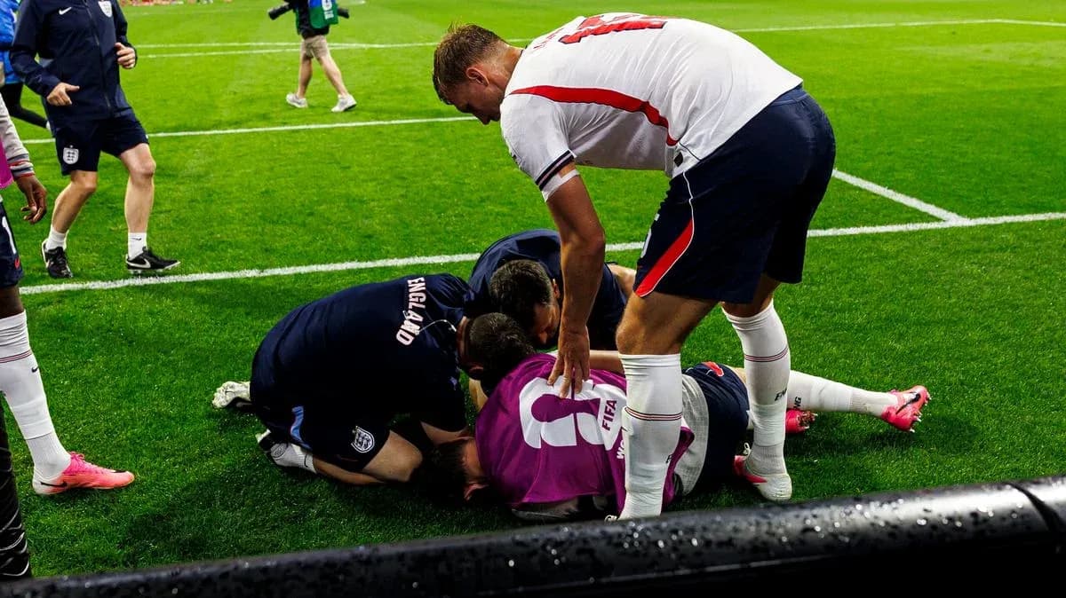 Players attending to an injured teammate on the field Players attending to an injured teammate on the field
