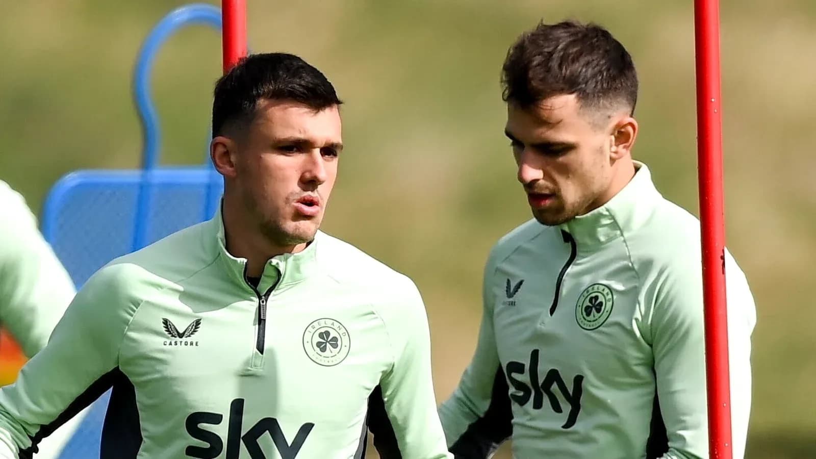 Two players in training discussing on the pitch Two players in training discussing on the pitch