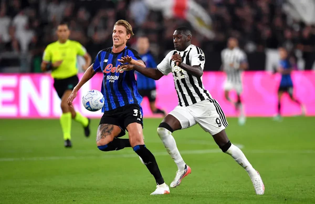 Two players competing for the ball in match Two players competing for the ball in match