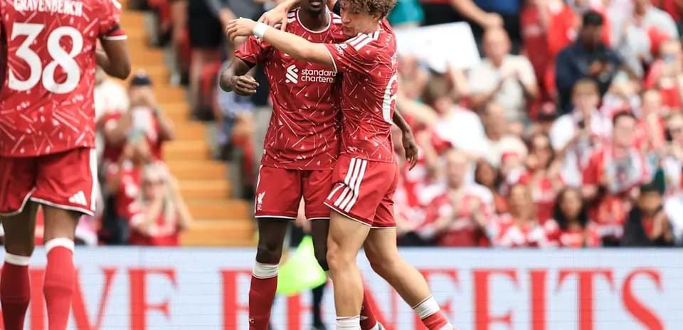 Two Liverpool players celebrating during a match Two Liverpool players celebrating during a match