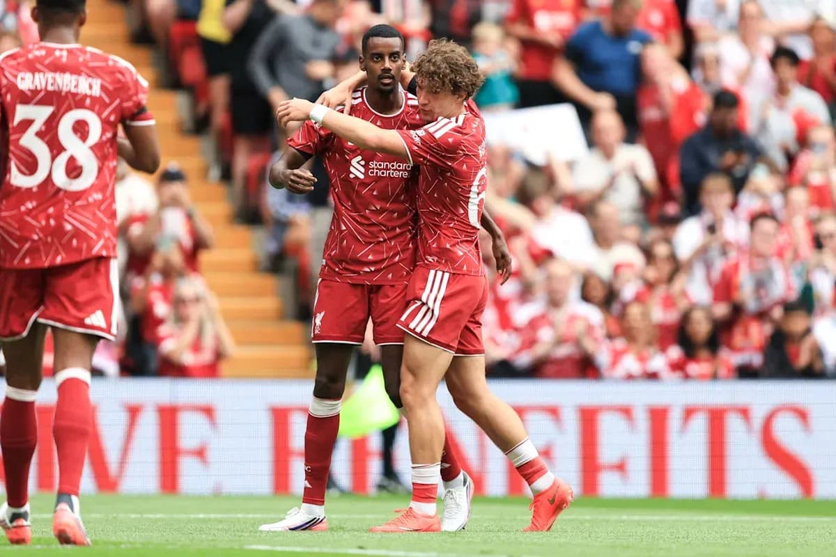 Two Liverpool players celebrating during a match Two Liverpool players celebrating during a match