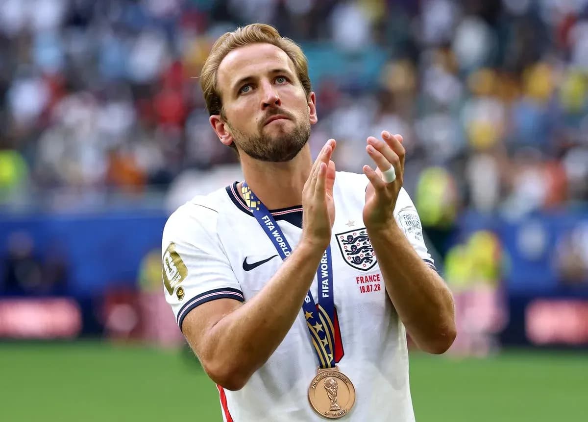 Player wearing medal and applauding on the pitch Player wearing medal and applauding on the pitch