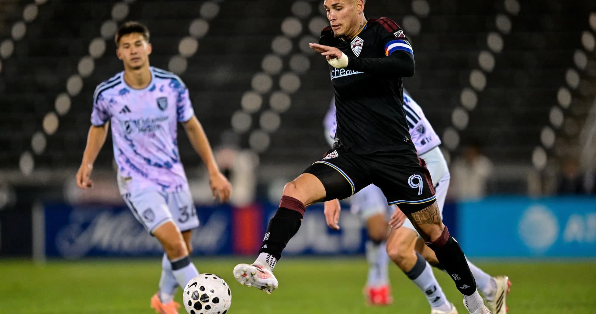 Player dribbling the ball during MLS match Player dribbling the ball during MLS match