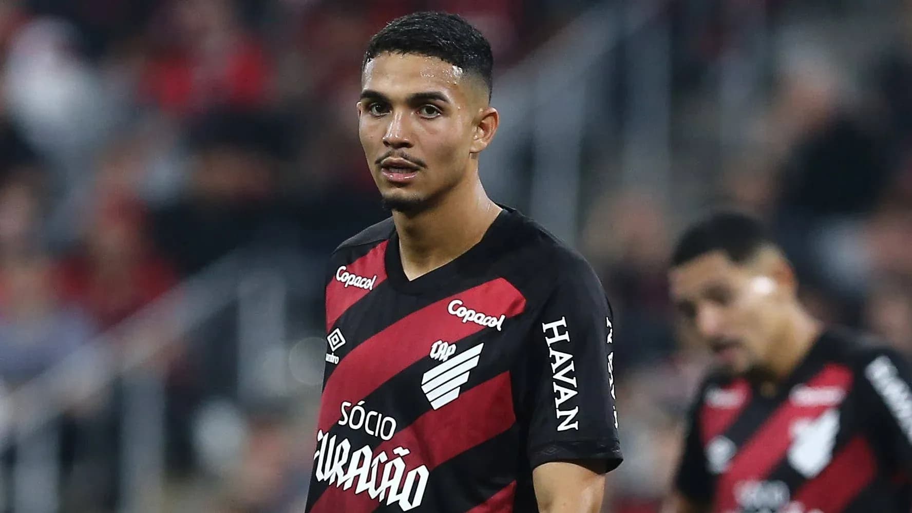 Player wearing red and black jersey during match Player wearing red and black jersey during match