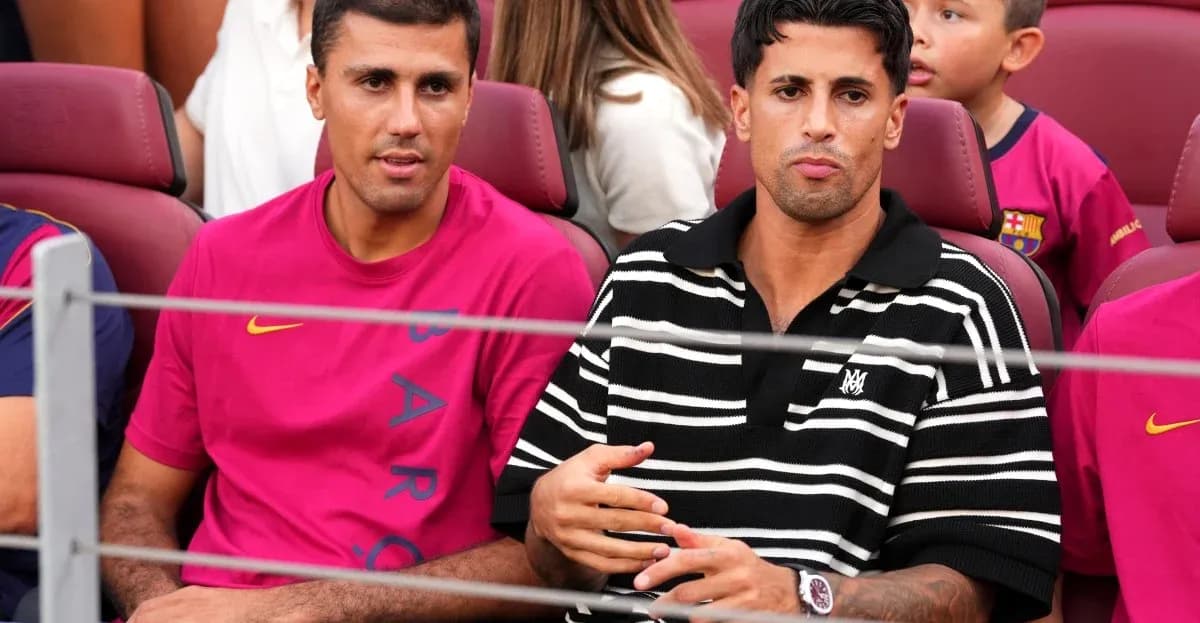 Two men seated in stadium wearing team apparel Two men seated in stadium wearing team apparel