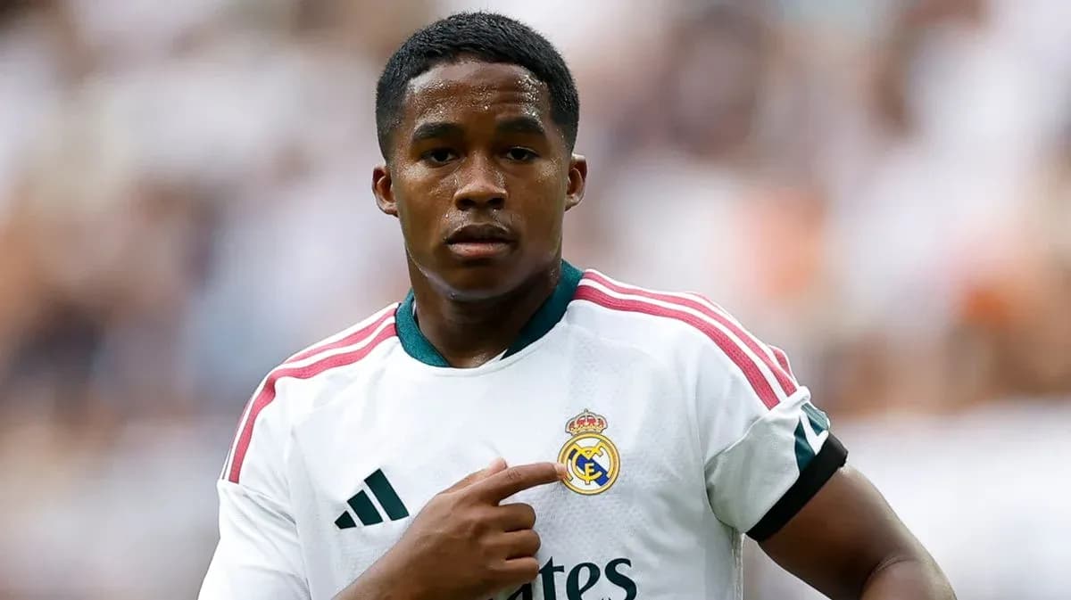 Player pointing at Real Madrid club logo on jersey Player pointing at Real Madrid club logo on jersey