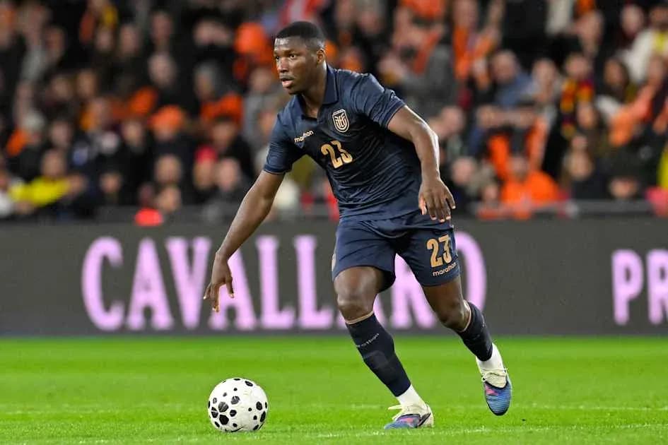 Player dribbling the ball during a football match Player dribbling the ball during a football match