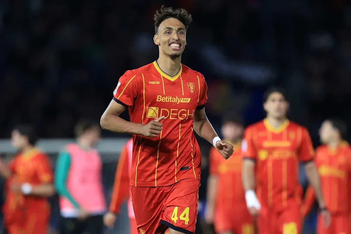 Player celebrating a goal in red team uniform Player celebrating a goal in red team uniform