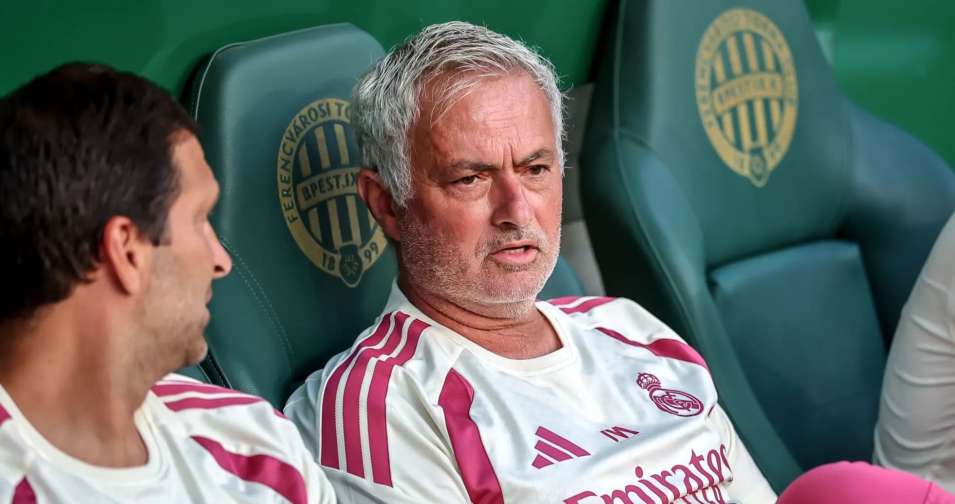 Manager discussing tactics on bench during match Manager discussing tactics on bench during match