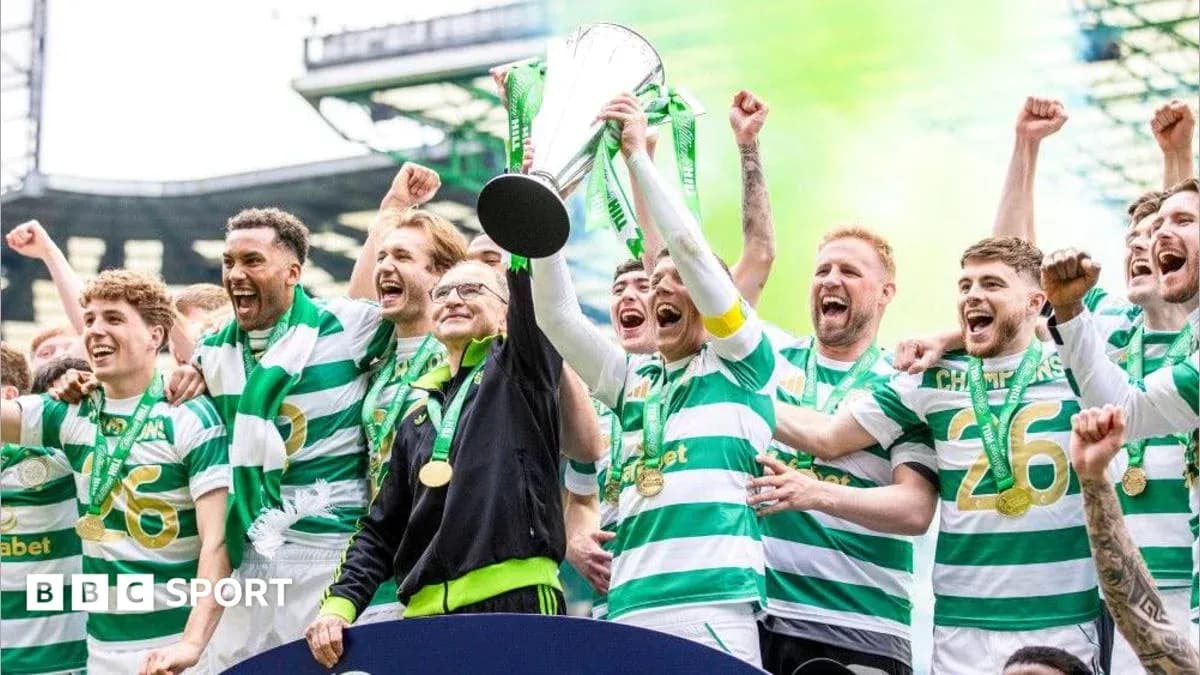 Celtic players celebrating with trophy and medals Celtic players celebrating with trophy and medals