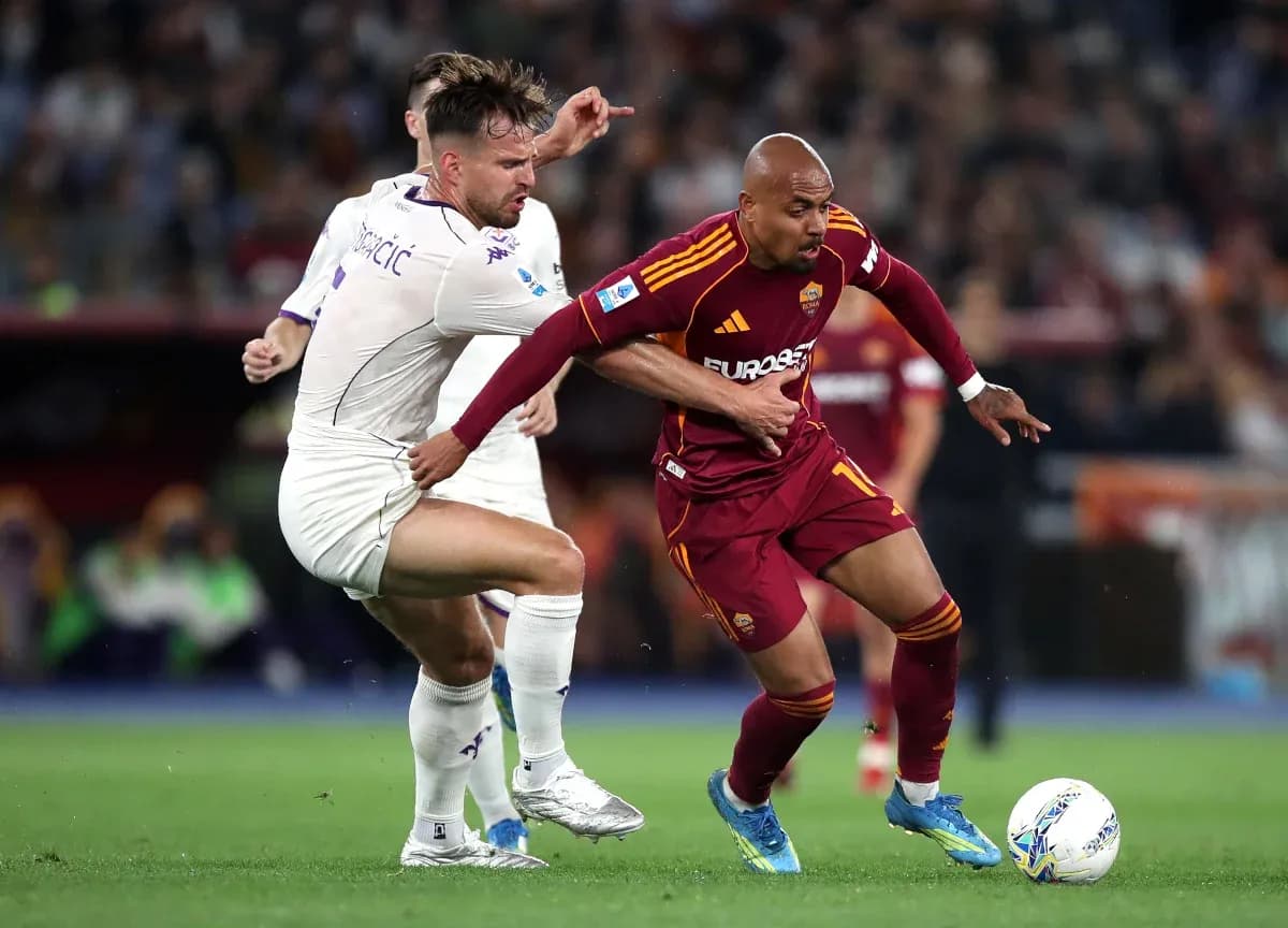 AS Roma player dribbling past Fiorentina opponent AS Roma player dribbling past Fiorentina opponent