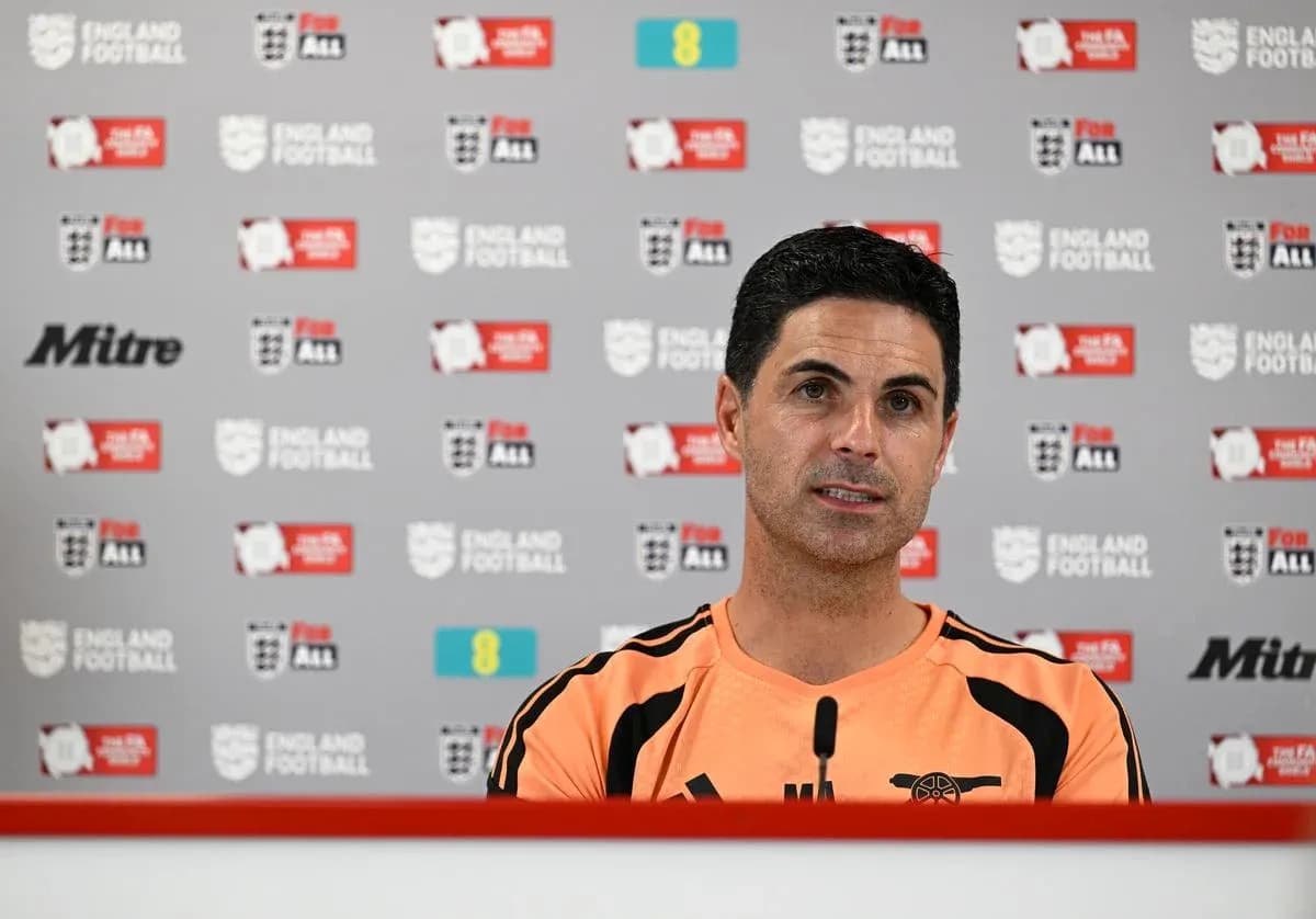 Manager speaking at press conference with logos behind Manager speaking at press conference with logos behind