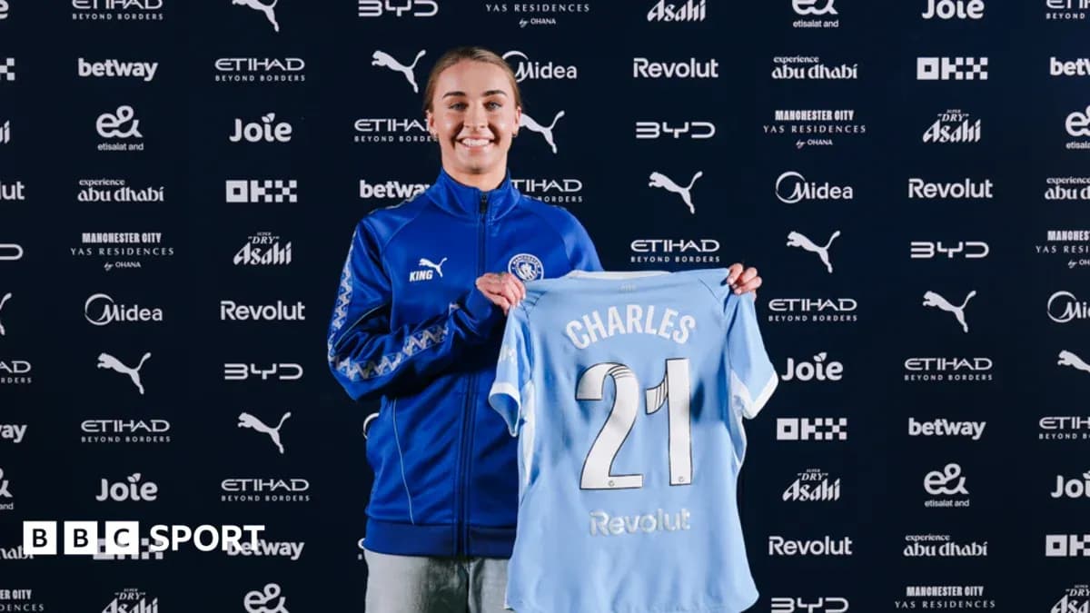 Player holding Manchester City jersey during presentation Player holding Manchester City jersey during presentation
