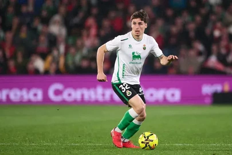 Player dribbling ball during a football match Player dribbling ball during a football match